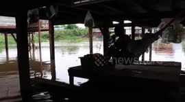 Homes flooded as river bursts its banks following rain in central Thailand
