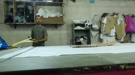 Palestinian labourers work inside a jeans factory, in Gaza city