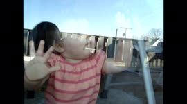 Girl Taps on Glass