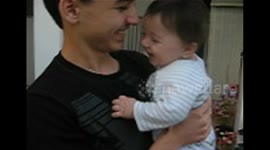 Man Holds Laughing Baby