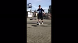 Great Score: Boy kicks basketball into hoop