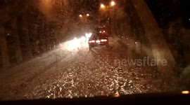 Woman shouts as she drives through swarm of fish flies