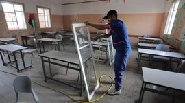 Palestinian workers clean the schools before the start of the new school year