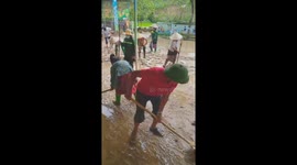 Hundreds clean up huge amount of mud after flash floods in Vietnam