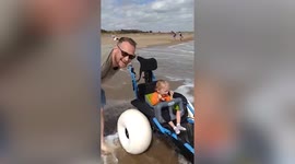 Mum moved to tears after disabled son finally gets to play in the sea thanks to beach wheelchair