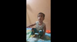 A 2 year old boy dances while watching baby shark cartoon video on YouTube.