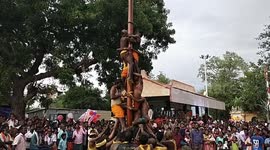 Contestants attempt to scale greasy pole during this traditional Indian sport
