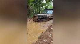Off-road jeep needs towing through waist-deep MUD during storm Ma On in the Philippines
