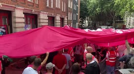 Union members hold giant CWU banner during rally as Royal Mail and Post Office workers begin their strikes
