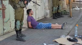 Israeli forces detain two Palestinian youths during clashes following a demonstration against settlements