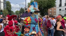 People wear flamboyant costumes at Notting Hill Carnival