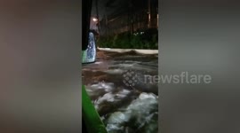 Water sloshes on flooded road following monsoon rains in the Philippines
