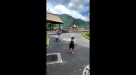 Little girl funny fell into the grass in a picturesque place!