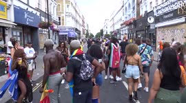 Notting Hill Carnival 2022 - crowds on Westbourne Grove on the way to festivities