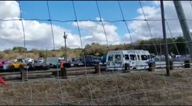 Vans skids around track at high speeds during Oxford banger race