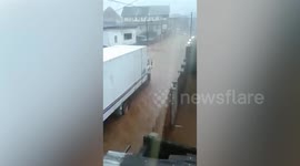 Cars drive through surging floods as storm batters Sierra Leone