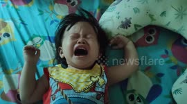 Baby stops crying when her face is covered with wet-tissue by her dad