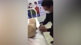 Nervous medical student decapitates infant doll in hilarious birth simulator test