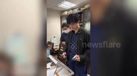 Medical students cut out paper bunny to practise surgery on training simulator