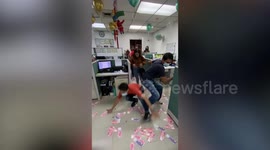 Employees rush to pick up money scattered in office on first day of work after New Year's Day