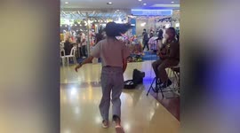 Policeman serenades shoppers for charity donations in Thai mall