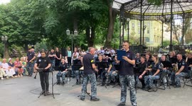 Odesa military orchestra performs the National Anthem of Ukraine in Odesa City Garden on July 16, 2022 as children and elderly are joining
