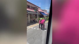 Kind bus driver stops to help elderly woman cross street in Singapore