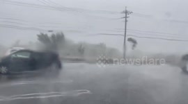 Motorists brave intense rainfall as Typhoon Hinnamnor hits Japan's Okinawa