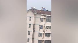 Terrifying moment boy plays on 7-storey building's roof in China