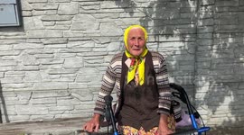 An old woman and her three daughter from a Ukrainian village lost their homes to Russian bombing; a walk around the ruined village
