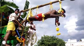Bizarre Indian festival sees devotees pull truck with hooks piercing their skin