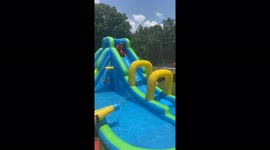 'Toddler goes down a water slide while riding his toy bike *MUNCHKIN MADNESS!*'
