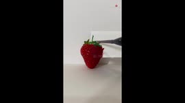 Brilliant artist perfectly matches hues while painting strawberry
