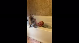Baby bobcat playing with baby during bath time!