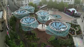 Enchanting urban garden with giant trees and plants installed in Birmingham city centre amongst historic buildings