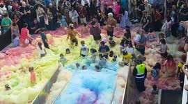 Hundreds turn out for foamy fun as artist unleashes cascading coloured rainbow in London's Greenwich