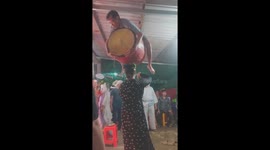 Incredible artist uses her head to lift man on top of drum