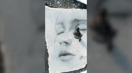 American artist braves Finland's freezing temperatures painting portraits on giant floating blocks of ice