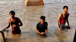 Locals wade through knee-deep water as Ganges' rises to dangerous levels in Patna