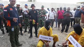 Reconstruction of Mutilation Cases against 4 Papuans Involving 6 Army Soldiers and 4 Civilians The Suspects demonstrate 50 scenes