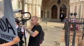 Pro-refugee protesters scuffle with far-right counter-protesters oustide Royal Courts of Justice.