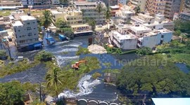 Excavator attempts to traverse floodwater as Bengaluru hit with heavy rain