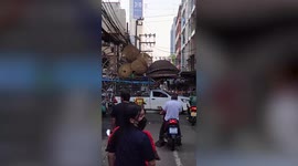 Overloaded pickup stuck after being caught under messy electric cables in Thailand