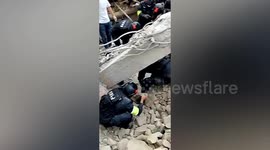China earthquake: Police officers dig man out of debris of collapsed house