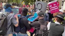 Pro-refugee protesters scuffle with far-right demonstrators outside Royal Courts of Justice