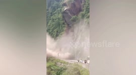 Landslide triggered by earthquake blocks road in southern China