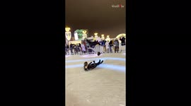 Ice skater pulls off stunning backflip over man lying on ground