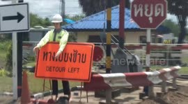 Driver mistakes mannequin for 'fearless' crossing guard in Thailand