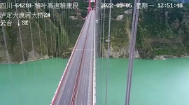 Car drives across suspended bridge during earthquake in southern China
