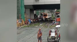 Car stuck on level-crossing as train approaches in the Philippines